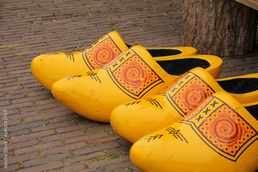 Wall mural Wooden clogs painted yellow and printed