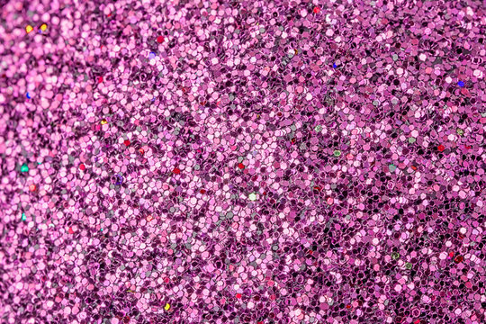 Bright picture of purple sparkles close-up. Festive background for sites and layouts.