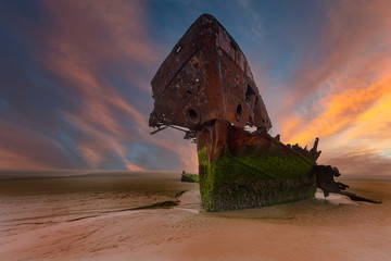 An old shipwreck boat abandoned stand on beach or Shipwrecked off the coast of Ireland
