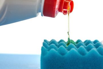 The detergent is squeezed onto a sponge. Sponge with liquid soap isolated on white background.