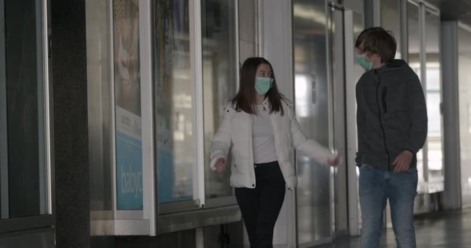 Responsible social gathering in time of pandemic. People wearing face masks for protection against Covid-19. Two friends hanging out in time of coronavirus