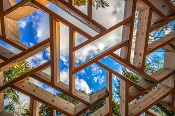 Geometric windows made of wood and blue cloudy sky. - Powered by Adobe