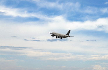 Fototapeta na wymiar plane on take-off, in the sky among white clouds