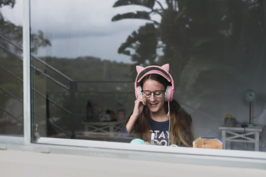 view of teenager through window