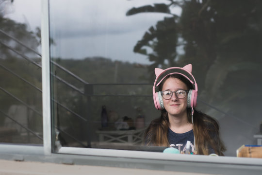view of teenager through window