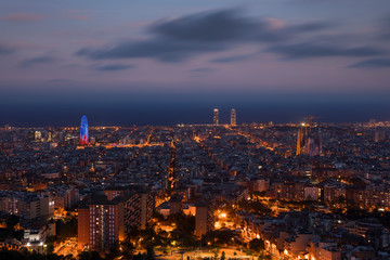 Fototapeta na wymiar Illuminated skyline with cathedral Sagrada Familia and tower Torre Agbar in Barcelona during night, street lights from Bunkers del Carmel.