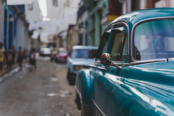 A green vintage car in Havana, Cuba