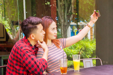 Young couple taking selfie picture in restaurant