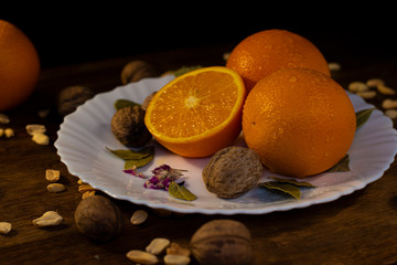 still life with oranges and nuts, slices of orange, peanuts, walnuts