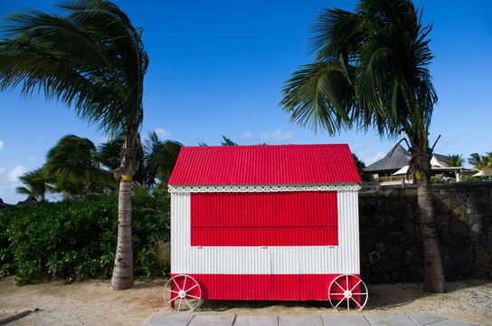 Concession Stand By Palm Trees Against Sky At Beach