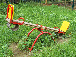 Children's swing balancer on green grass on street