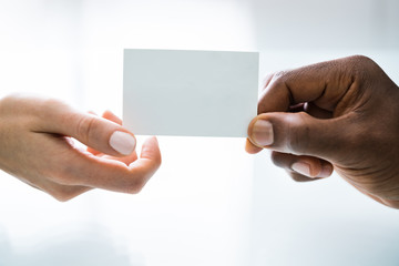 Person Hands Giving Visiting Card To Another Person