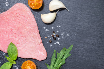 Red slices of raw beef with spices and herbs