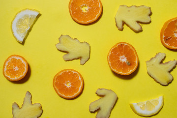 Raw ingredients of lemon, ginger and tea on yellow background