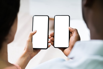 Two People Hands Holding Mobile Phones