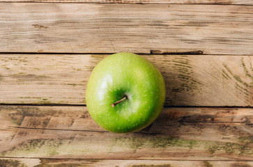 Green apple on rustic wooden table Top view. Minimal concept