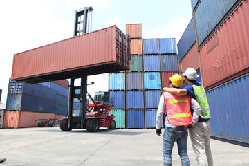 Engineering group working and they are loading container for support logistics and import export business