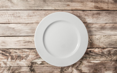 Vintage Table setting with plate on old rustic wooden table.