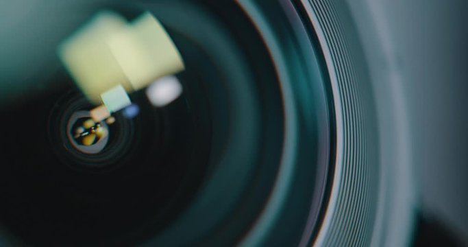 Macro close up of DSLR camera lens elements & light reflecting off glass