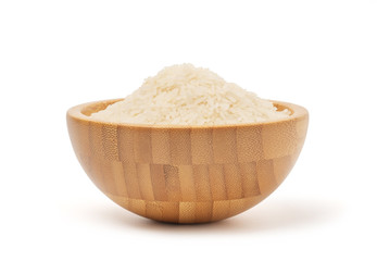 Uncooked rice in wooden bowl isolate on white background with clipping path