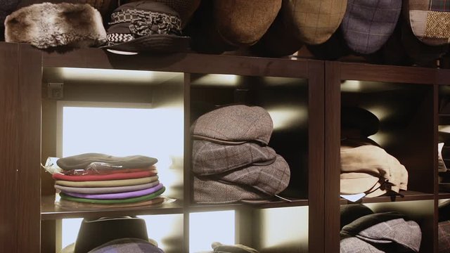 Clothing store showcase with variety of mens flat caps, womens hats and berets