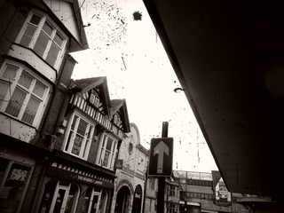 Low Angle View Of Confetti Falling By Buildings