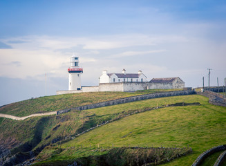 Fototapeta na wymiar lighthouse on a hill in Ireland 