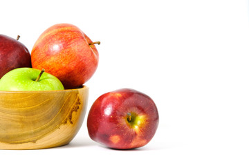 Group of green and red Apple fruit on a wooden bowl / basket isolated on white background