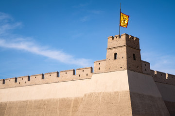 The majestic Jiayuguan City watchtower in Gansu Province, China. Chinese characters on black plaque: Jiayuguan.The majestic Jiayuguan Great Wall Corner Tower in Gansu , China.The turret of the wall © Liu Lei