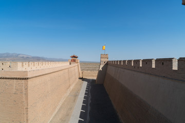 The majestic Jiayuguan City watchtower in Gansu Province, China. Chinese characters on black plaque: Jiayuguan.The majestic Jiayuguan Great Wall Corner Tower in Gansu , China.The turret of the wall © Liu Lei