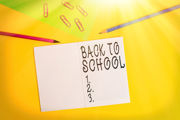 Conceptual hand writing showing Back To School. Concept meaning is the period relating to the start of a new school year Blank notebook pencils marker paper sheet colored background