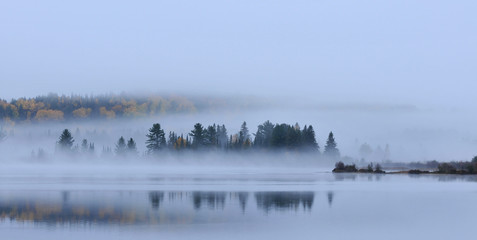 Morning fog mist on Lake of Two rivers Algonquin Park Ontario Canada