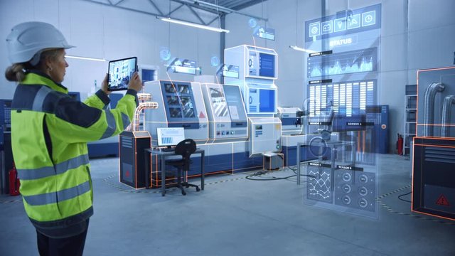 Industry 4.0 Factory: Female Engineer Uses Digital Tablet Computer with Augmented Reality Software to Connect with High-Tech CNC Machinery and Visualize Maintenance and Diagnostics of the Equipment