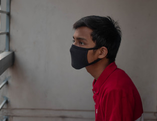 Man wearing mask at home quarantine isolation and hoping for freedom of corona virus.Concept of coronavirus quarantine. MERS-Cov. Novel coronavirus (2019-nCoV)