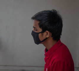 Coronavirus and Air pollution pm2.5 concept.American boy wearing mask for protect pm2.5  and hoping and praying for stop corona virus outbreak.Usa coronavirus and epidemic virus symptoms.