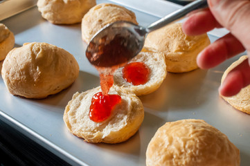 Muffins on a tray with strawberry jam 