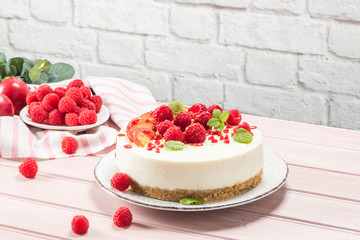 Cheesecake with fresh raspberries and plums
