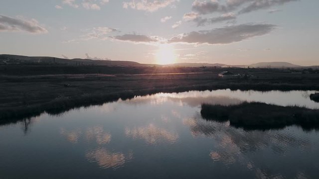 Flight over the lake during sunrise