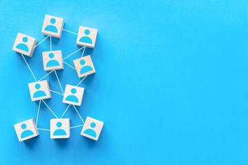 Connecting people or social media networking concept using wood square block on blue background