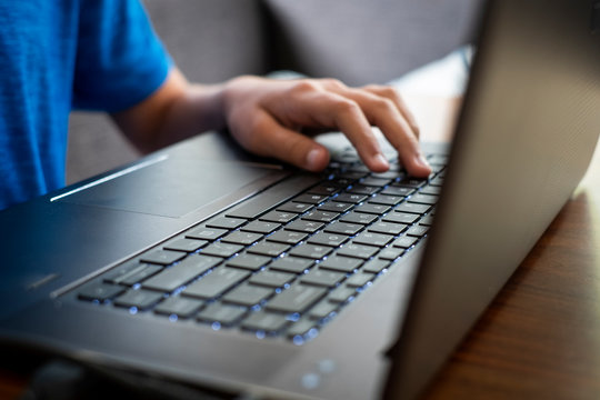 Student does his school assignments on a laptop at home during the Covid-19 shelter in place order.
