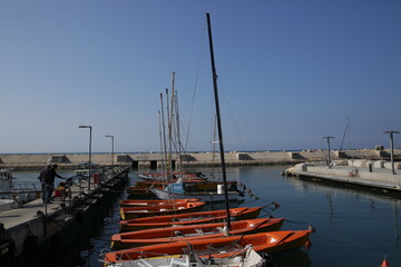 orange training yachts in a yacht marina in the Mediterranean.
