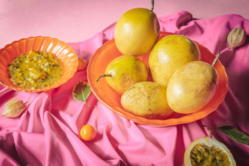 Passion fruit still life on a background of pink tablecloths. Concept of tropical, freshness, summer, tea