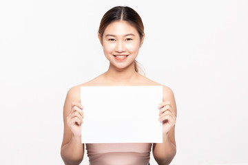Attractive Asian young woman smile with holding blank paper for display text or cosmetics product so happy and cheerful with healthy Clean and Fresh skin,isolated on white,Beauty Cosmetology Concept