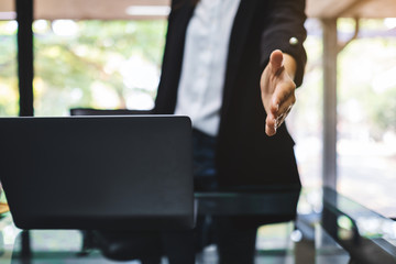 Businesspeople open hand to shaking hands in office