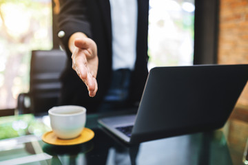 Businesspeople open hand to shaking hands in office