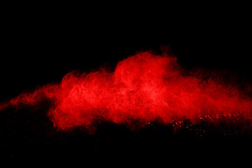 Fototapeta na wymiar abstract red powder explosion on black background.abstract red powder splatted on black background. Freeze motion of red powder exploding.