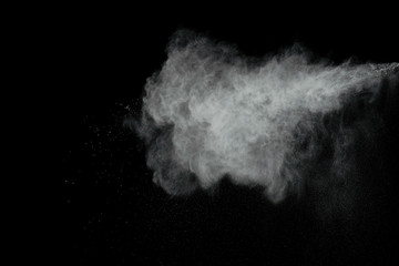 White powder explosion isolated on black background