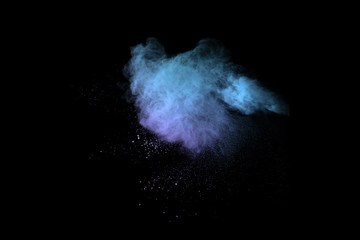 Blue powder explosion on black background. Colored cloud. Colorful dust explode. Paint Holi.