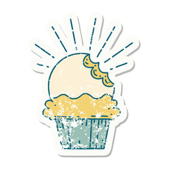 grunge sticker of tattoo style cupcake with missing bite