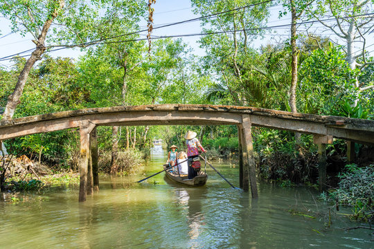 Tourists from China, Korea, America, Russia experiencing a basket boat tour at Tan Phong island or Cu Lao Tan Phong in Tien Giang, Vietnam. Near Ben Tre city.